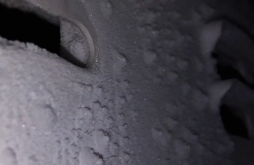 Heavy frost accumulated inside a low-temperature freezer