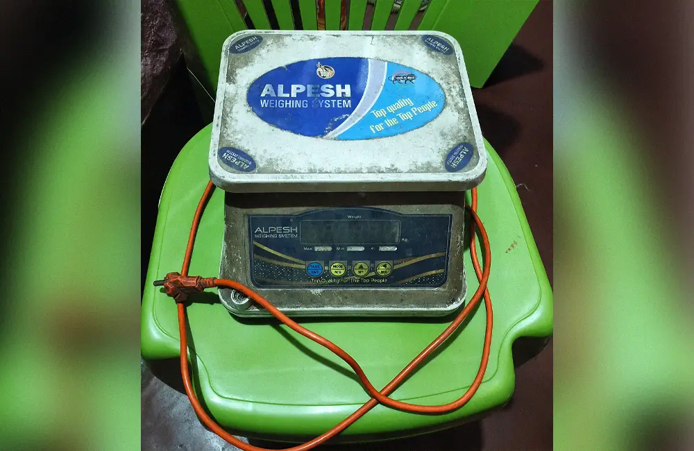 Digital electronic scale representing the measurement of refrigerant charge by weight.